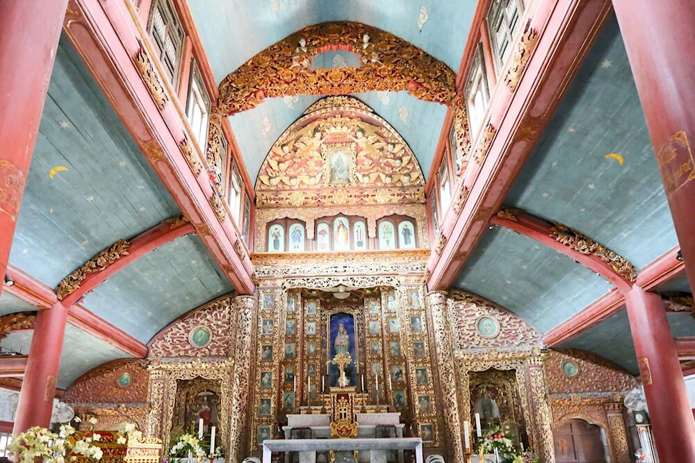 The sanctuary is made of wood with gilded lacquer panels, embodying the traditional Vietnamese style of worship